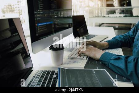 Asian man working code program developer computer web development working design software on desk in office. Stock Photo