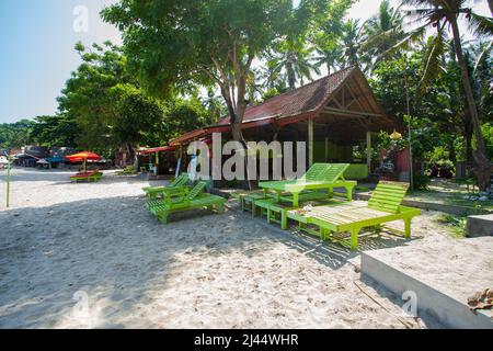 Parasols and sun loungers on Virgin Beach, a white sand beach in Karangsarem, East Bali, Indonesia. Stock Photo
