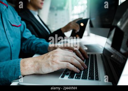 Developing programming and coding technologies working in a software engineers developing applications together in office. Stock Photo