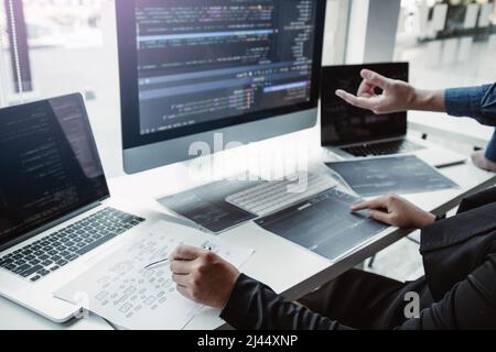 Two asian team working development of programming and encryption technology website design programmers on desk in office. Stock Photo