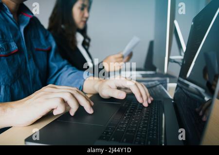 Two partnerships developing programming and coding technologies working on laptop and analyzing together. Stock Photo