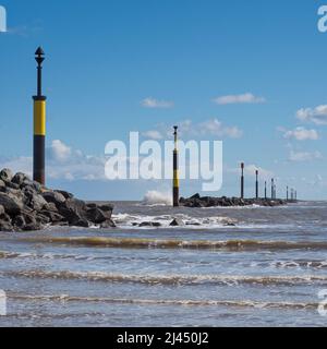 Waves crashing against breakwater at entrance to bay, Sea Palling, Norfolk Stock Photo