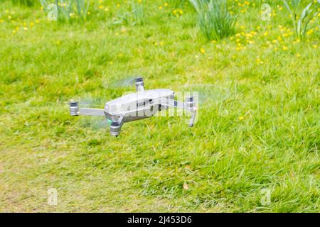 young man flying and controlling DJI magic drone Stock Photo