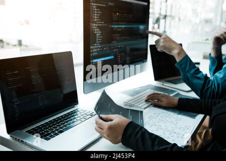 Two asian team working development of programming and encryption technology website design programmers on desk in office. Stock Photo