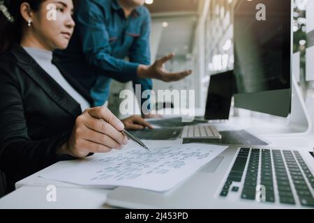 Two partnerships developing programming and coding technologies working on laptop and analyzing together. Stock Photo