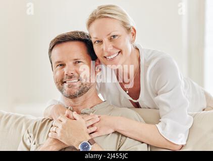 I married my best friend. Shot of a young couple being affectionate on the sofa at home. Stock Photo