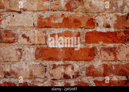 Old brick wall background, brick wall texture, structure. old broken brick, cement joints, close-up. crumbling from old age. construction, repair. con Stock Photo