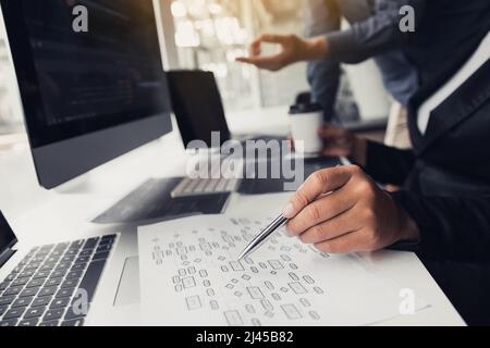 Two partnerships developing programming and coding technologies working on laptop and analyzing together. Stock Photo