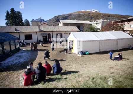 Briancon (French Alps, south-eastern France), November 5, 2021: exiles in the garden surrounding the church. Reportage at St Catherine's Church on mig Stock Photo