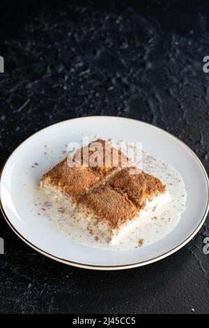 Cold baklava on a dark background. Baklava with pistachio milk. Traditional Turkish cuisine delicacies. The new trend is baklava. close-up. local name Stock Photo