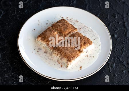 Cold baklava on a dark background. Baklava with pistachio milk. Traditional Turkish cuisine delicacies. The new trend is baklava. close-up. local name Stock Photo