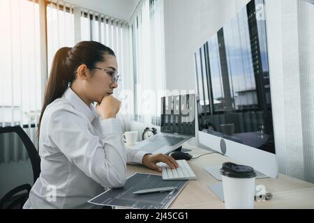Asian female software developers are stressed in analyzing code-based systems. Stock Photo