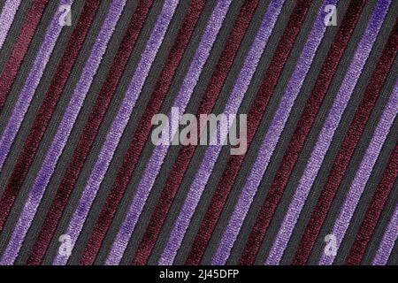Corduroy background with lines pattern close up. Texture of violet corduroy textile - useful as background. Diagonal line texture. Stock Photo