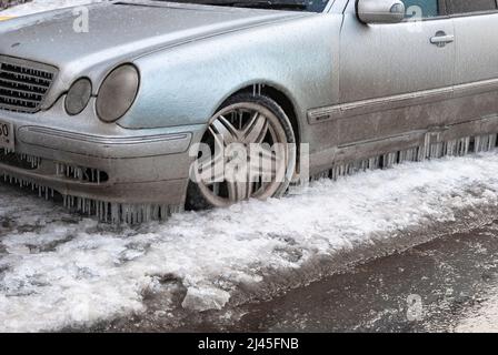 Freezing rain. The car froze to the road. Close-up Stock Photo