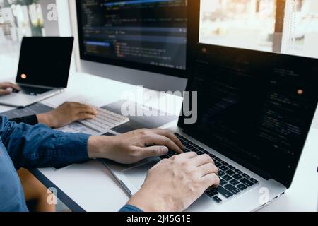 Two software developers are analyzing together about the code written into the program on the computer. Stock Photo