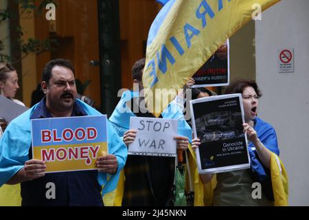 Sydney, Australia. 12th April 2022. Ukrainians protested at HSBC HQ at 100 Barangaroo Avenue, Barangaroo as they still haven't exited Russia and continue doing business with them. Protesters say conducting business in Russia means funding the war in Ukraine. Protesters told HSBC that they have blood on their hands. Credit: Richard Milnes/Alamy Live News Stock Photo