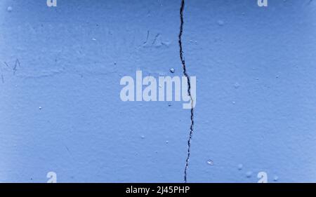 Background wall with paint that begins to peel off with age. Cracked wall, paint Stock Photo