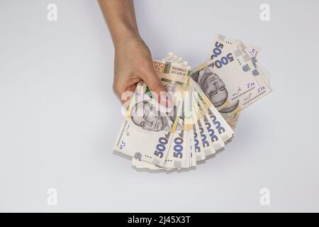 Female hands hold ukrainian money currency. Several thousand hryvnia banknotes by 500. Money of Ukraine. Stock Photo