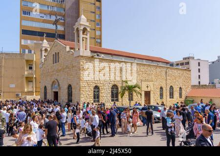 Haifa, Israel - April 10, 2022: Crowd gather at the Greek Catholic Melkite Church of Mar Elias (St. Elijah Cathedral), on Easter Palm Sunday, in Downt Stock Photo