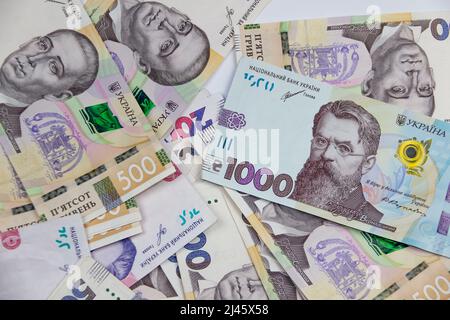 Ukrainian money currency of different denominations scattered. Hryvnia banknotes 200, 500 and 1000 on background. Money of Ukraine. Stock Photo