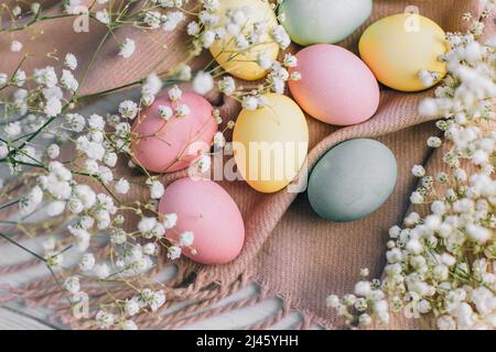 Happy Easter card with multicolored eggs and flowers pastel toned. Stock Photo