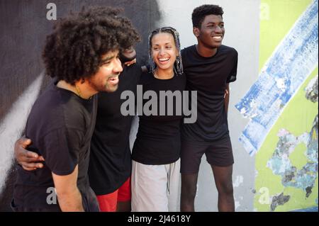 Diverse young friends smiling with positive attitude Stock Photo