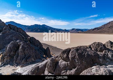 Rock island on the dry lake bed of the Racetrack Playa in Death Valley National Park Stock Photo