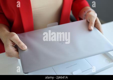 Woman holds an Apple Macbook Pro laptop in package Stock Photo