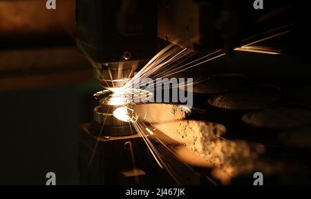 Laser cutting technology flat sheet metal steel material processing with sparks Stock Photo
