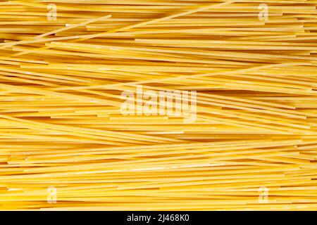Dry Uncooked Spaghetti Pasta Noodles Background Texture. Stock Photo