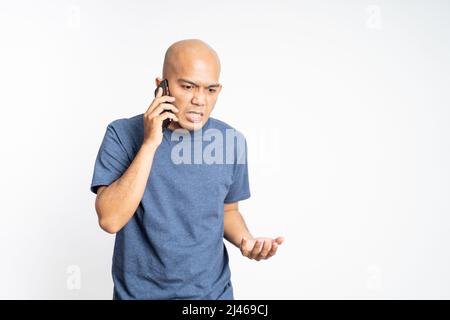 Serious asian bald man listening while calling Stock Photo