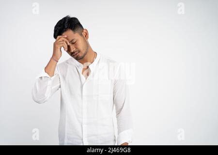 man with disappointed face with hands holding forehead while thinking Stock Photo