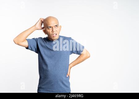 confused bald man holding his bald head Stock Photo