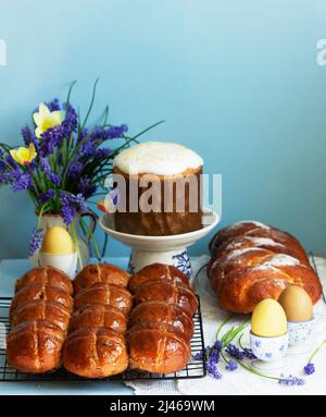 Traditional Easter pastries, cross buns, Easter cake and sweet challah and Easter eggs. Stock Photo