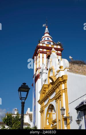 The catholic church in Castilblanco de los Arroyos, Seville, Spain. Storks nest on the bell tower Stock Photo