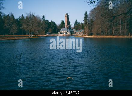 Big mansion on the other side of the lake in a forest Stock Photo