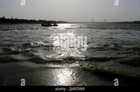 Indian devotees enjoy boat ride in holy river Ganges and Yamuna at the bank of Sangam In Prayagraj, India. Stock Photo