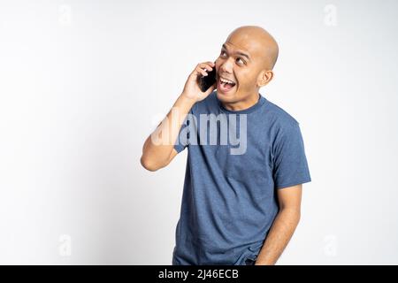 bald man laughing while making phone call Stock Photo