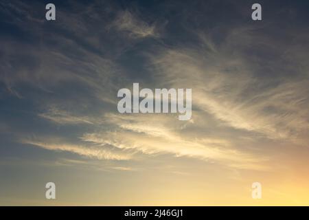 Background of cirrus clouds on the burning dawn in the sky after golden sunset Stock Photo