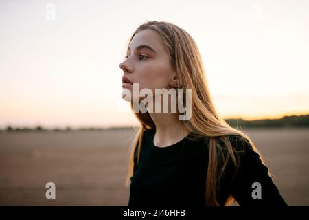 Portrait of a young woman with long blond hair Stock Photo