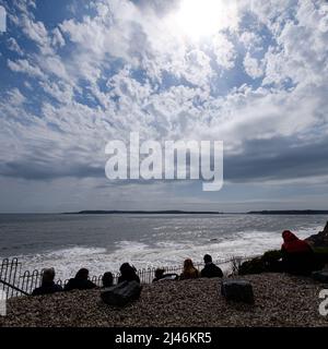 The seascape from Tenby to Caldey Island - people enjoying the viewing watching the clouds in the sky Stock Photo