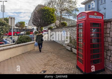 GIBRALTAR, UK - APRIL 7, 2022 - Old vintage red English telephone both at street of Gibraltar. Stock Photo
