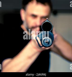 man holding a hunting rifle with a sight. Self-defense. Protection of Ukraine Stock Photo