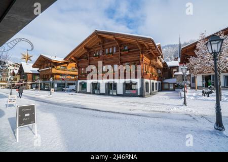 Wood chalet in Gstaad village in winter time Stock Photo