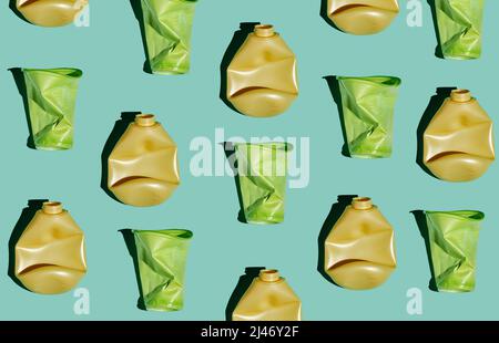 Modern flat lay pattern of crumpled plastic bottles and cups on light blue background, conscious consumption and plastic waste concept Stock Photo