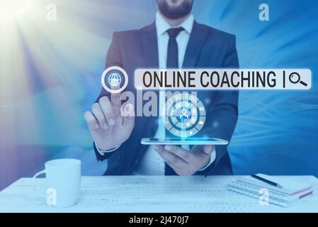 Hand writing sign Online Coaching. Conceptual photo Learning from online and internet with the help of a coach Man holding Screen Of Mobile Phone Stock Photo