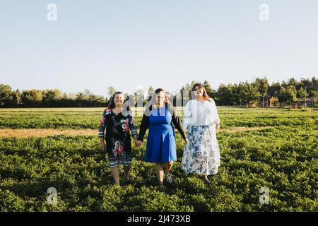 Female family walking in a natural environment on a sunny day afternoon. Lifestyle portrait. Mother's day Stock Photo