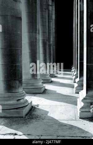 Classical stone pillars detail on the facade of a building. Stock Photo
