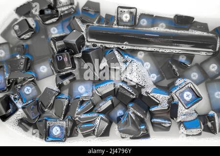 removed buttons of the keyboard sink with soap solution Stock Photo