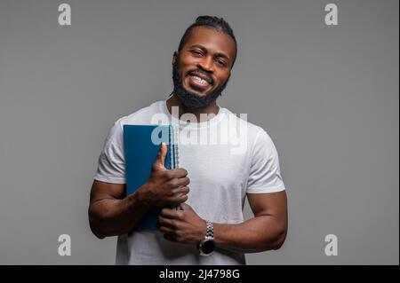Cheerful male student posing for the camera Stock Photo